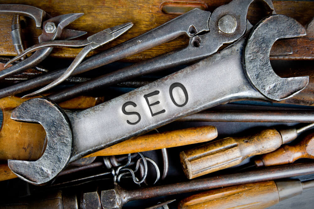 A bunch of old metal and wooden tools laid out, representing the various SEO tools that SEO consultants use