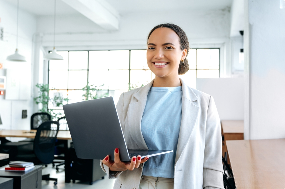 An SEO professional smiling about providing quality national and local SEO services to her clients 